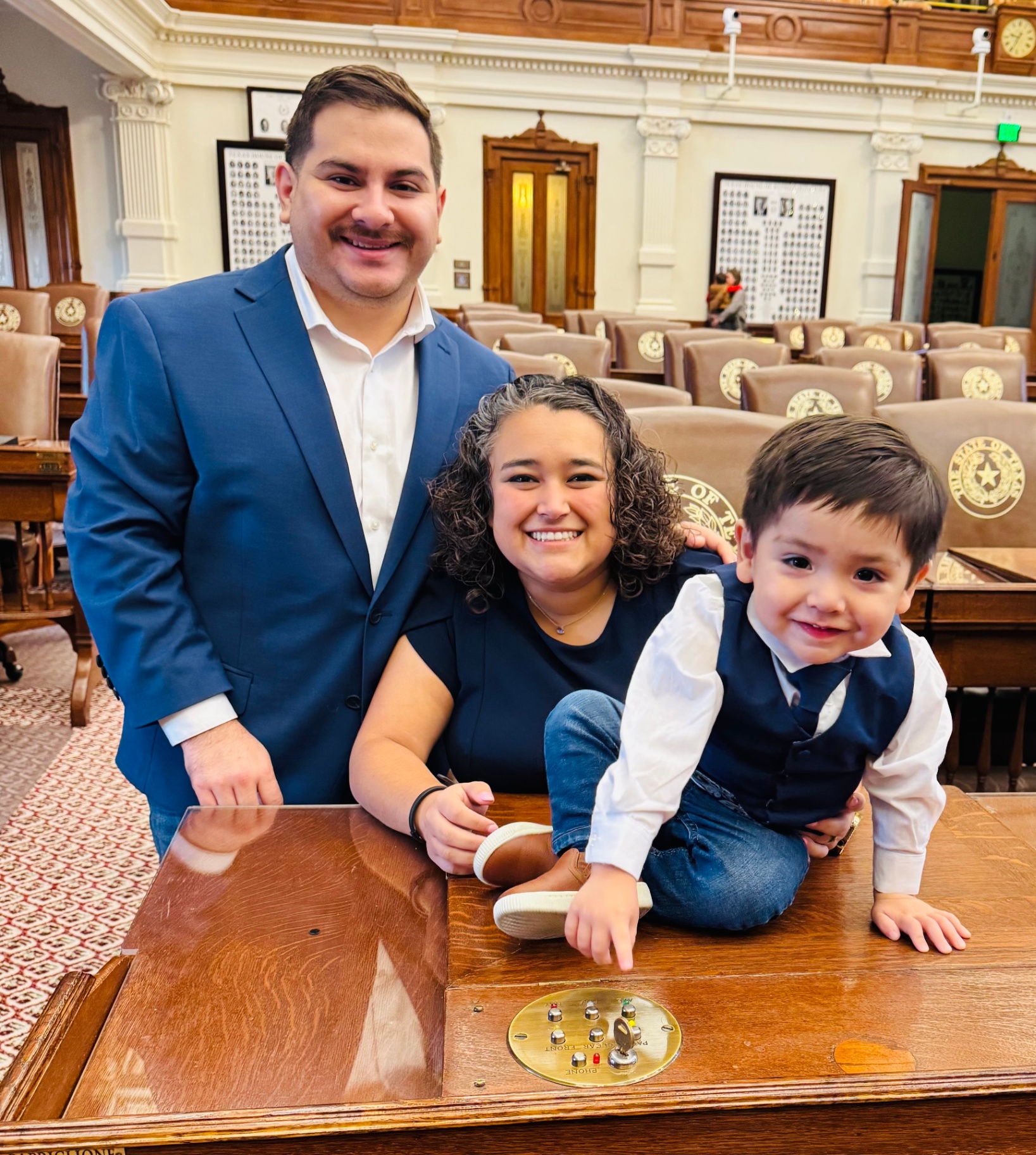 Denise Villalobos holding her son Ezekiel beside her husband Ruben at the Texas Capitol.